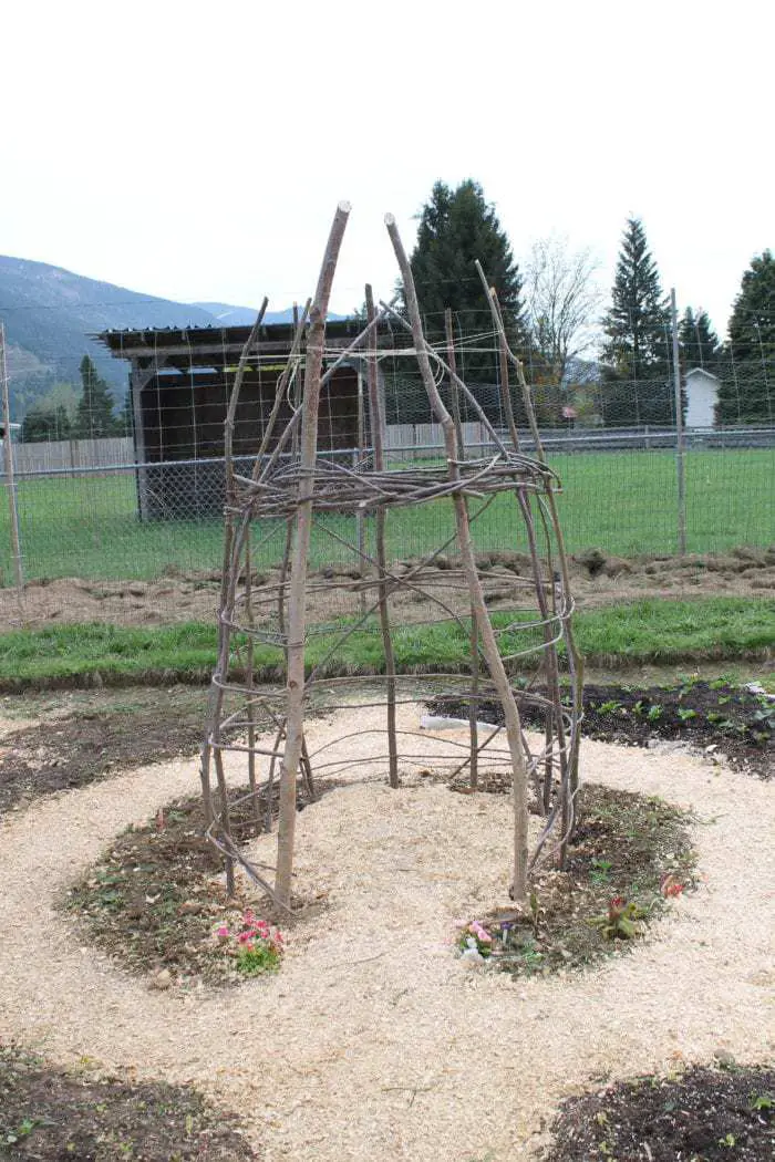 Build a fun DIY Wooden playhouse garden trellis for your kids garden!