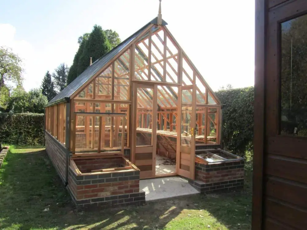 Wooden and brick greenhouse with cold frames #greenhouse